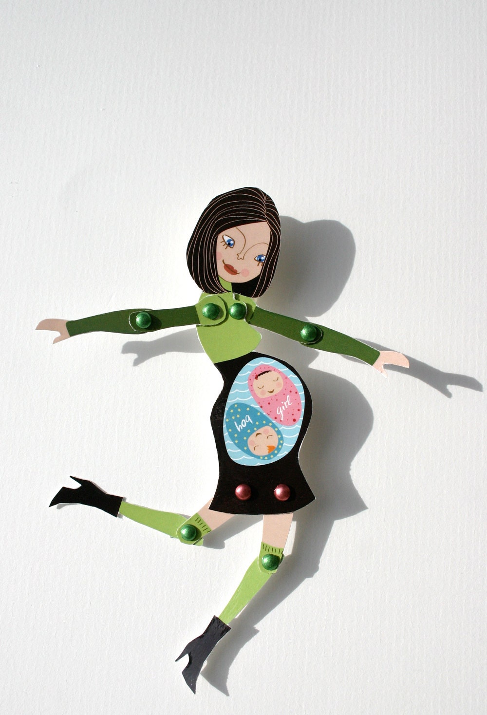 Articulated pregnant paperdoll with green and brown dress. It's a girl and a boy.