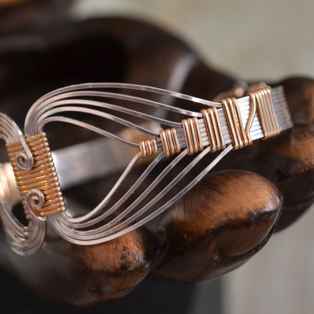Egyptian wire wrapped Bracelet with a Twist.  Sterling Silver and 14K Gold filled. Size Small
