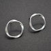 Modern twisted circle post earrings.