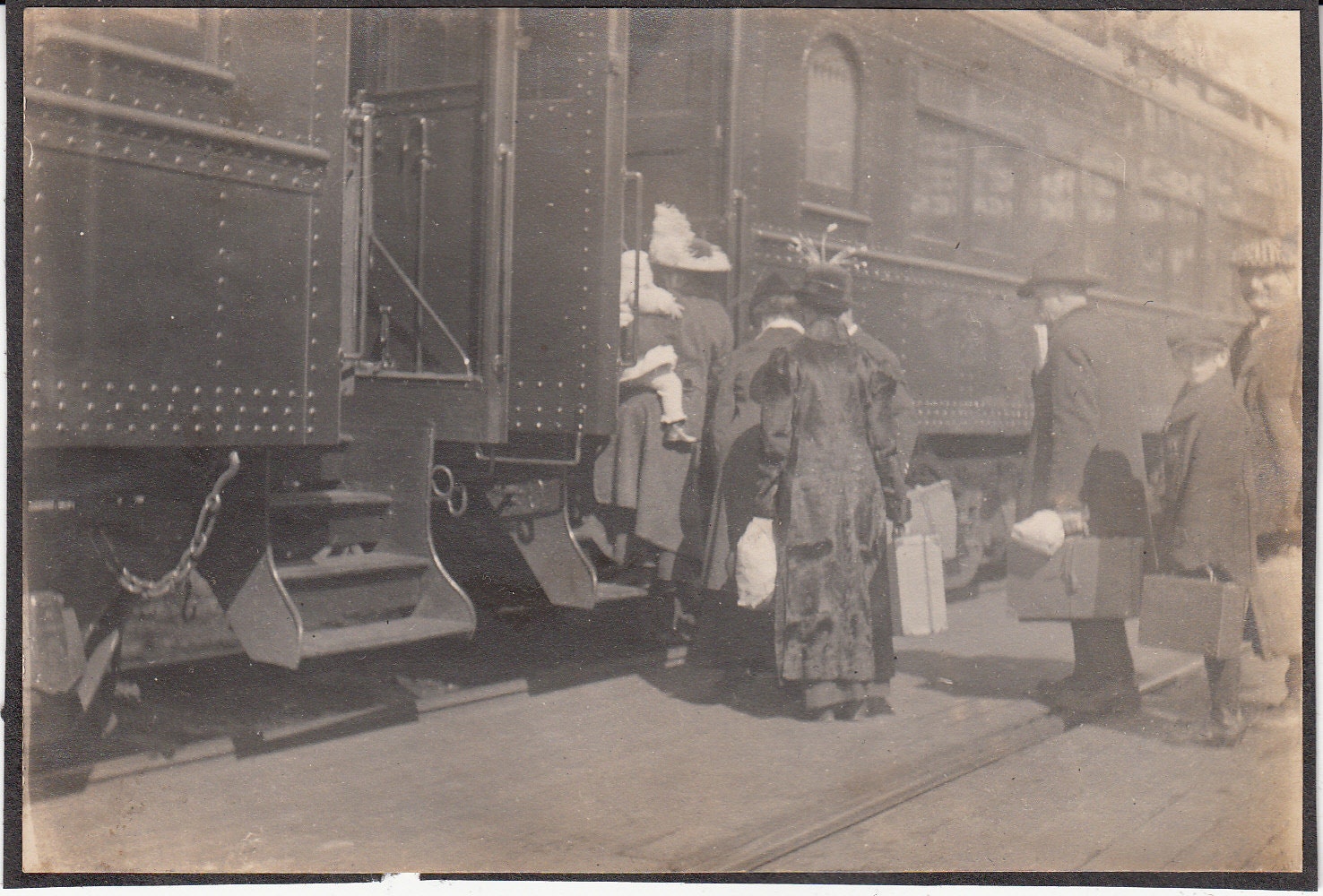 Vintage/Antique photo of people in fancy clothes getting into the train