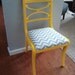 yellow gloss chair with blue and white chevron seat.
