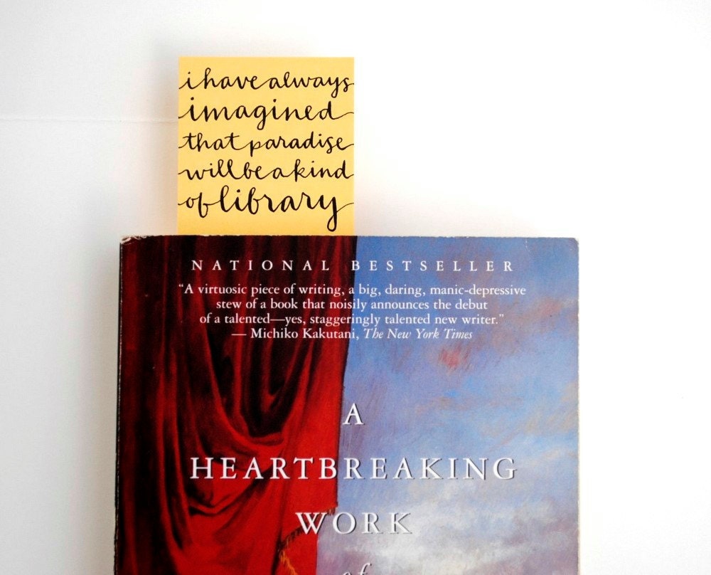 Yellow Bookmark with Handwritten Calligraphy . I Have Always Imagined That Paradise Will Be a Kind of Library