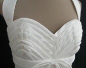 A 50s style cocktail dress in ivory duchess satin. Have this dress custom made like many others in our store. All sizes welcome.