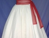 A stunning one-strap 50s style cocktail dress with a beautiful waist defining red sash.