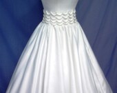 A 50s wedding or cocktail dress in white duchess satin