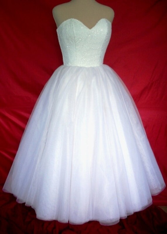 A 50s inspired wedding gown, intricately detailed corset cocktail dress