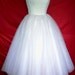 A 50s inspired wedding gown, intricately detailed corset cocktail dress