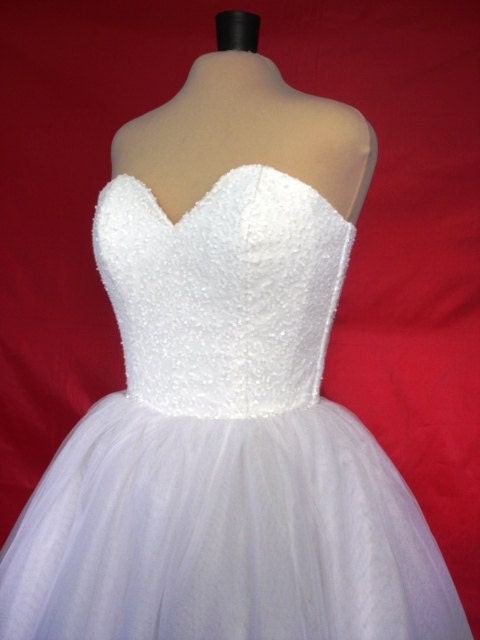 A 50s inspired wedding gown, intricately detailed corset cocktail dress