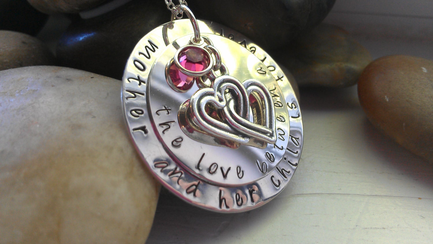 the love between a mother and her child is forever sterling handstamped necklace