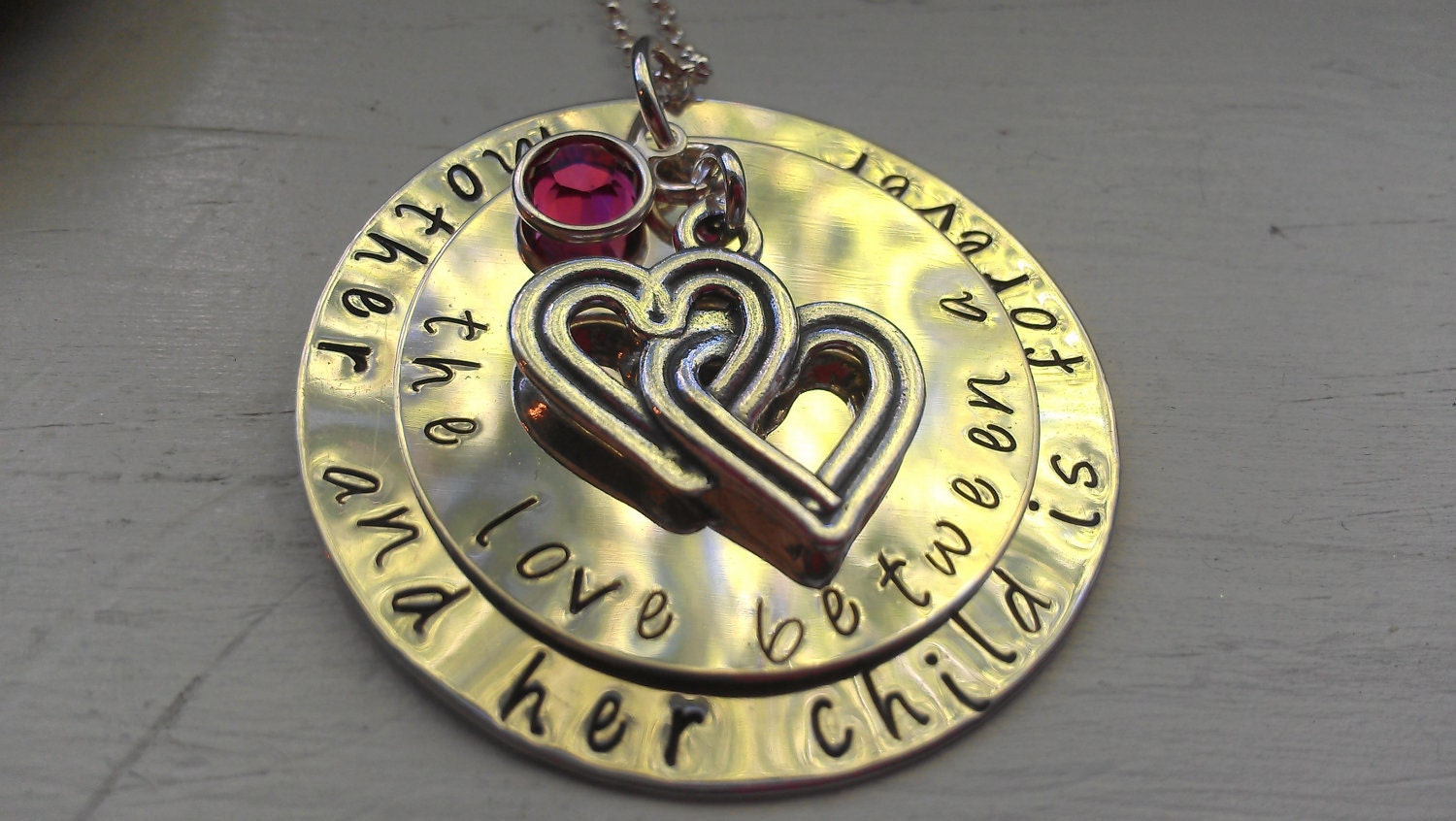 the love between a mother and her child is forever sterling handstamped necklace