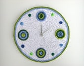 Crochet wall clock with blue and green circles and buttons