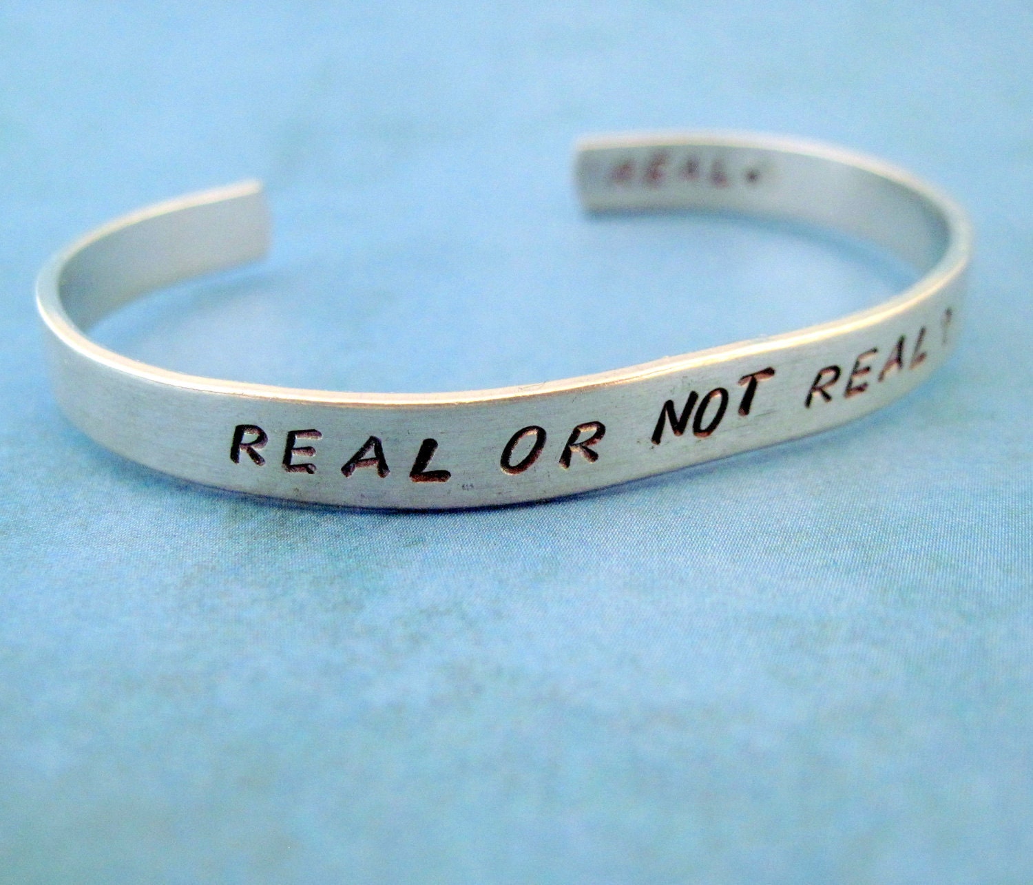 Hunger Games Inspired Bracelet - Real or Not Real - 2-Sided Hand Stamped Aluminum Cuff - customizable