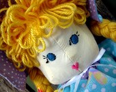 Vintage stuffed Doll with embroidered face and braided yarn hair.  Includes removable clothing and shoes.  50s inspired.