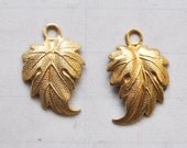 Two sets of left and right leaf charms, raw brass