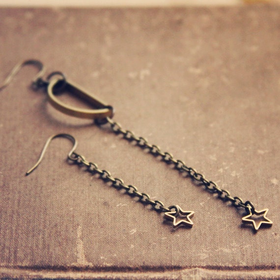 moonchild.  a pair of golden assymetrical moon and star earrings.