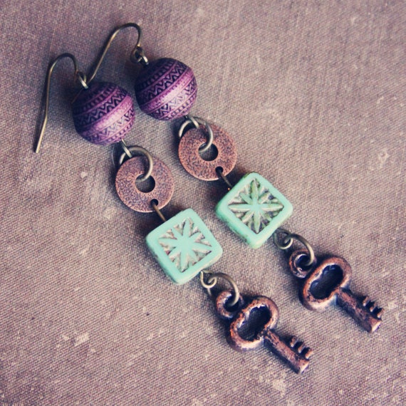 suri.  a pair of purple and teal rustic key earrings.