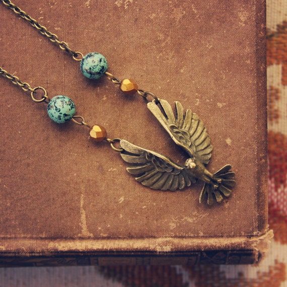 RESERVED FOR NAVIWING skylar.  a beaded brass bird in flight necklace.