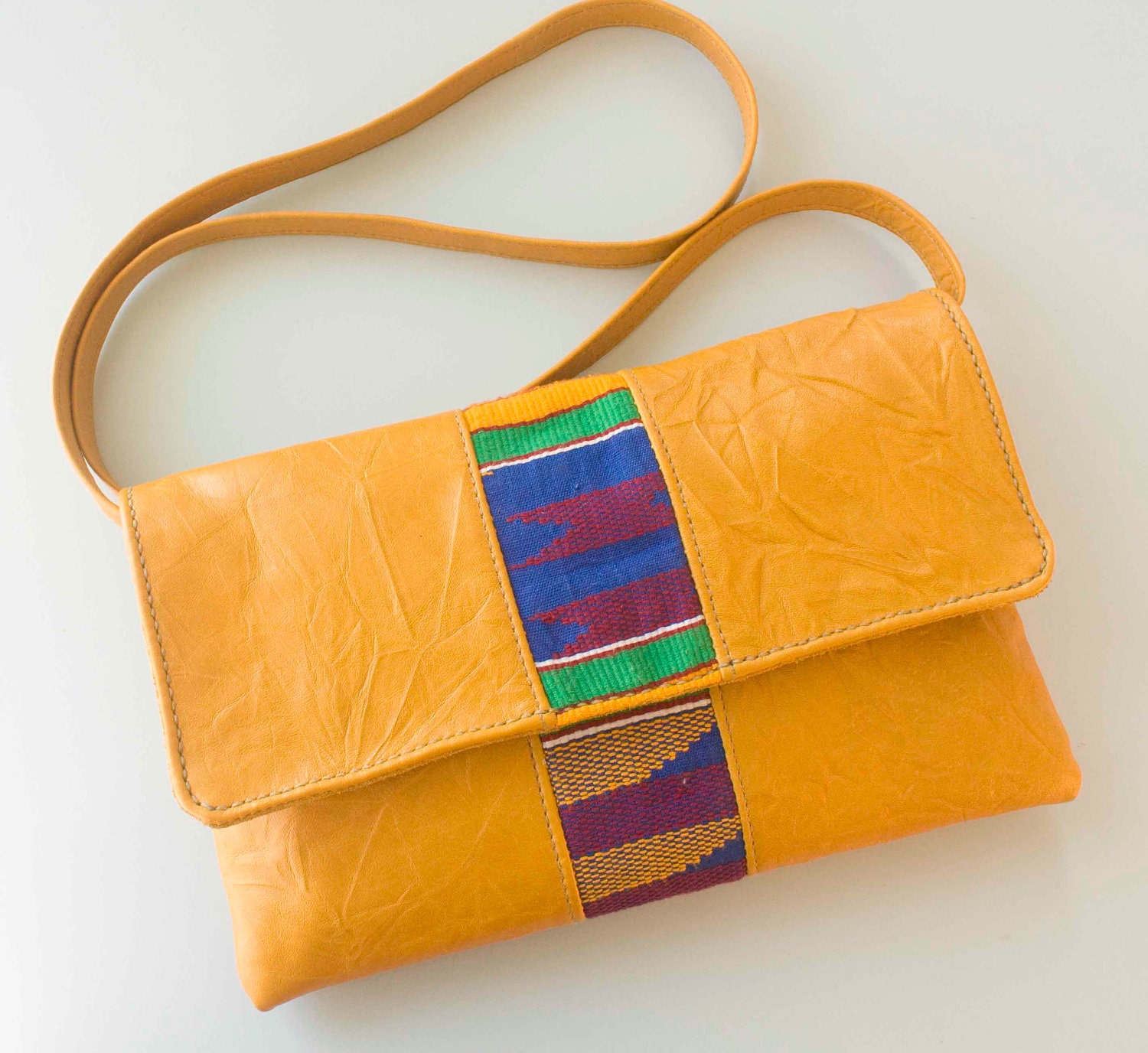 Leather and Kente clutch bag with detachable strap