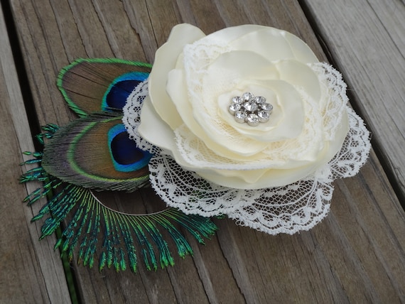 Bridal ivory satin lace flower hair clip accented with a rhinestone, peacock eye and sward feathers
