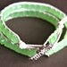 Leather wrap bracelet made with pearl colored leather, lime green cube crystals and silver dragonfly button clasp