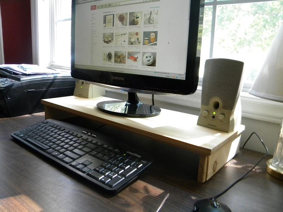 Computer monitor/tv stand organizing station . slide the keyboard under when you need more work space