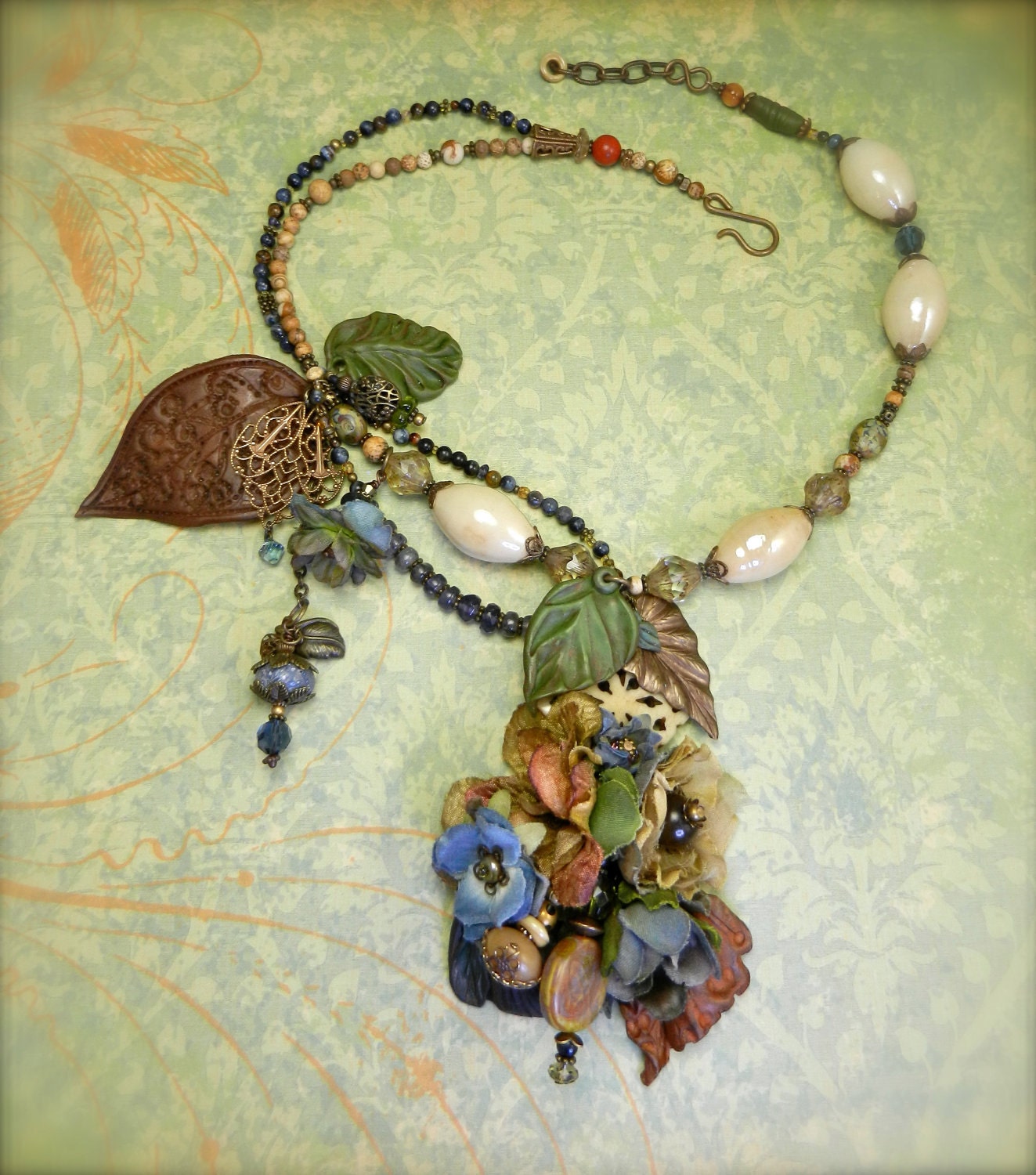 COUNTRY DREAMS-- as simple as can be--with Sapphires, vintage beads, wooden accent button & dangling polymer leaves.