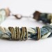 Fabric bracelet. Pastel fabric hand braided with antique copper metal rings.Mint, rose, blue and green colors. Medium size