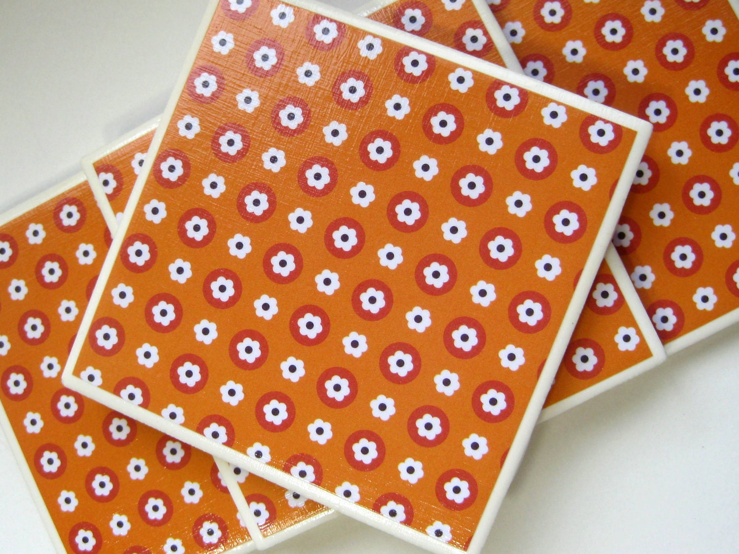 Orange Drink Coasters - White Tile with Orange, Dark Red, White, and Black Circle and Flower Design