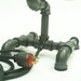 Desk lamp. Beer bottles. Plumbing pipe & fittings. Table lamp.
