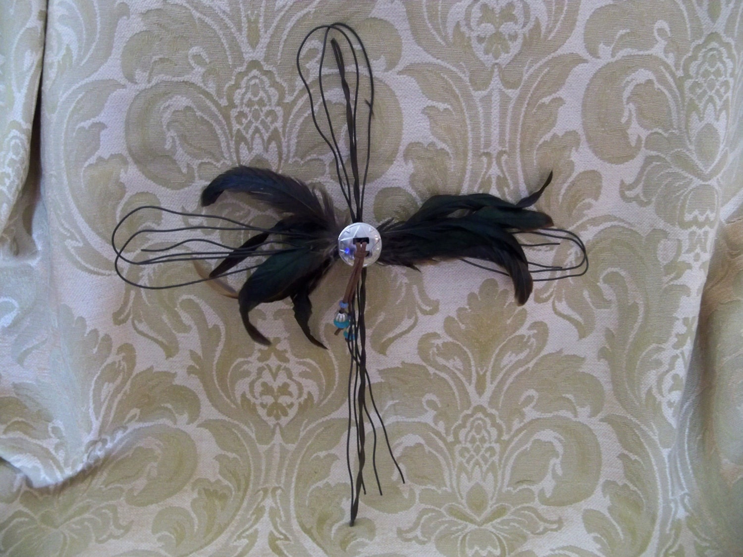 Wire cross with feathers