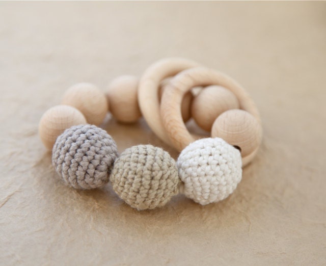 Teething toy with crochet wooden beads and 2 wooden rings. Light grey, beige, white wooden beads rattle.