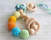 Teething toy rattle with crochet wooden beads and 3 wooden rings. Yellow, orange, light green, aqua blue/ cyan.