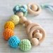 Teething toy rattle with crochet wooden beads and 3 wooden rings. Yellow, orange, light green, aqua blue/ cyan.
