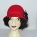 Womens Red Cloche felt hat Black silk flower rhinestones and feathers.