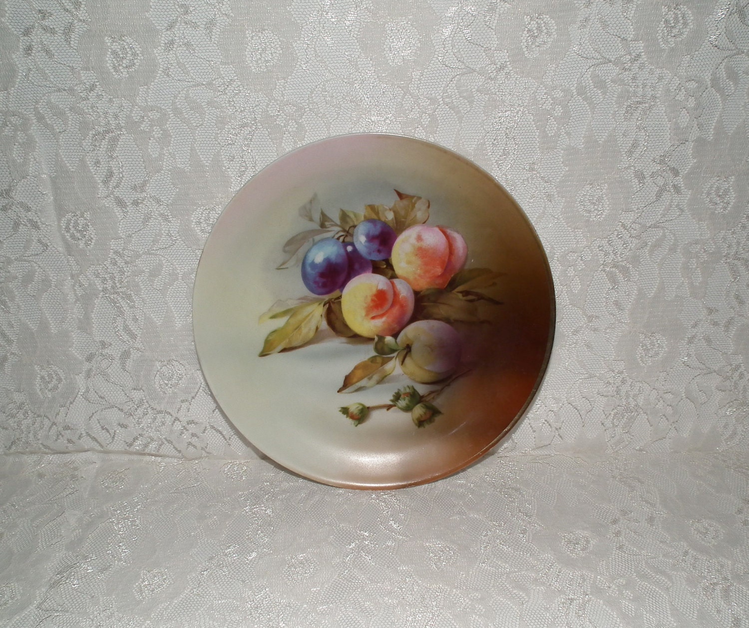 Handpainted plate with peaches and grapes marked J & C