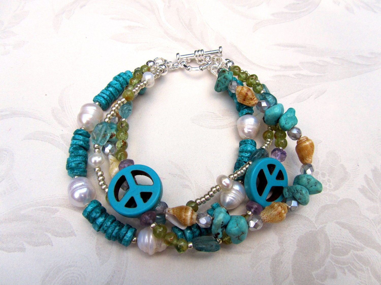 Beachy boho shell, freshwater pearl, amethyst, peridot, blue apatite and turquoise peace sign bracelet