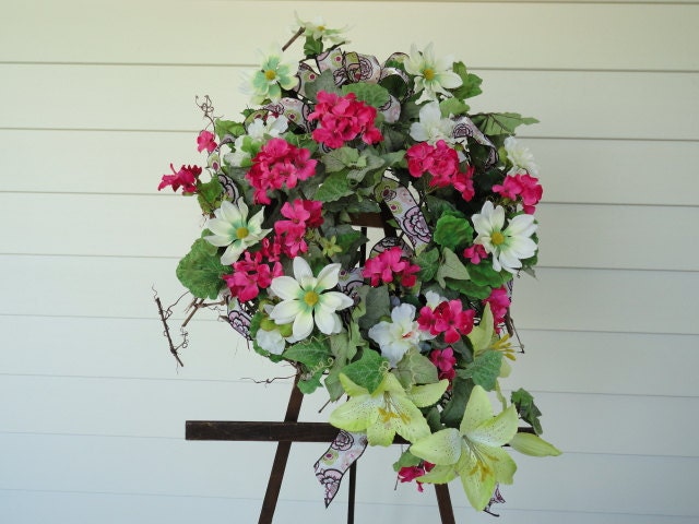 RETRO WREATH:  Hot pink geraniums,star astors with lime green centers,lime lillies,all tied together with hot pink,black and lime ribbon