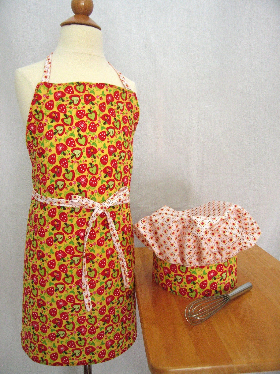 Little Girl Apron and Hat Set with Apples, Strawberries and Cherries on a Yellow Background - Riley Blake fabric