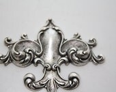 Ornate fleur de lis ornament - sterling silverplated