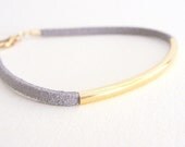 Grey suede leather bracelet with golden arc tube. Grey lovely pastel