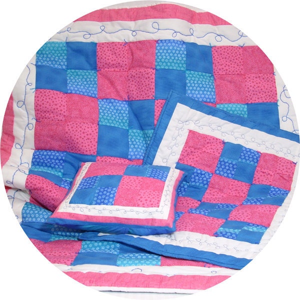 This one-of-a-kind child sized hot pink and blue quilt includes a matching doll quilt and pillow.