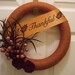 Fall Yarn Wreath with felt flowers berries and feathers