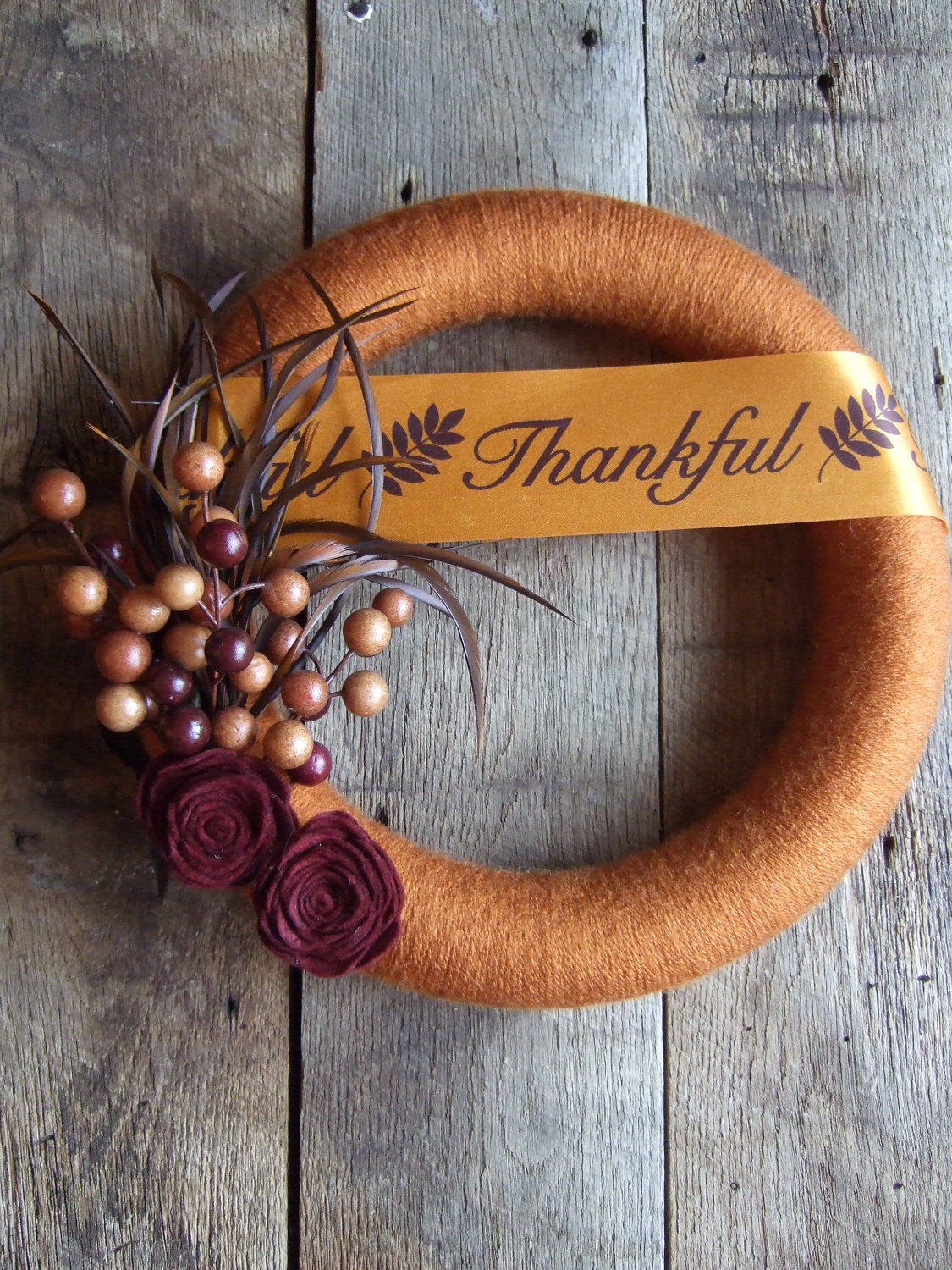 Fall Yarn Wreath with felt flowers berries and feathers