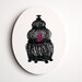 Caged... An illustration of a pink bird in a black bird cage infused onto a high-gloss alluminum 14" oval