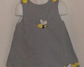 A Line Dress with embroidered bee. Sizes are 3mo, 6mo, 12mo, 18mo, 2T, 3T, 4T, 5 and 6.