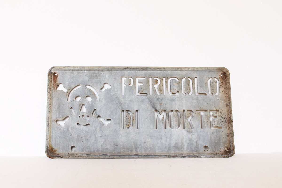 Vintage industrial Italian skull danger metal sign