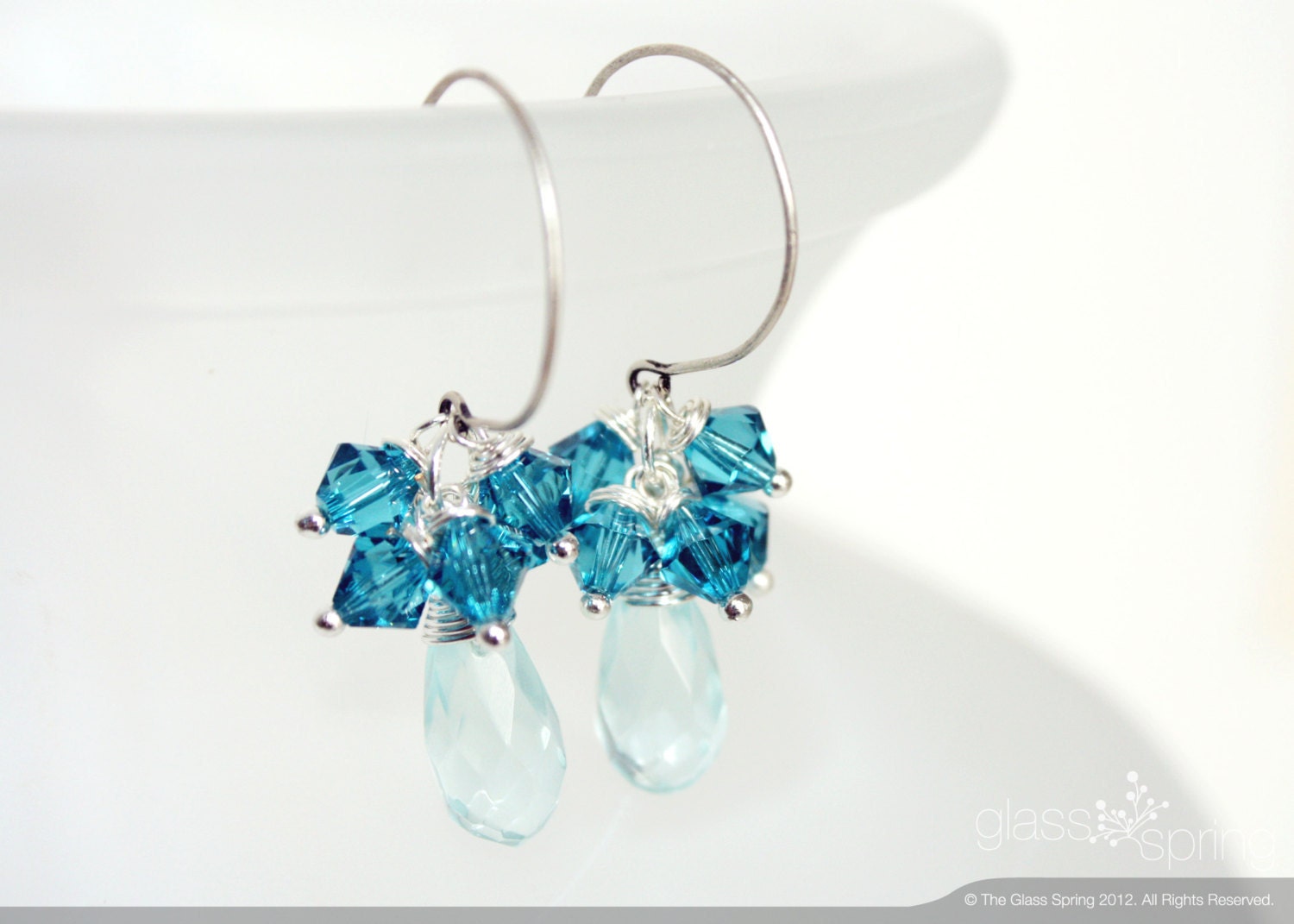 Earrings wire wrapped with blue glass and swarovski crystal with round silver ear wire.
