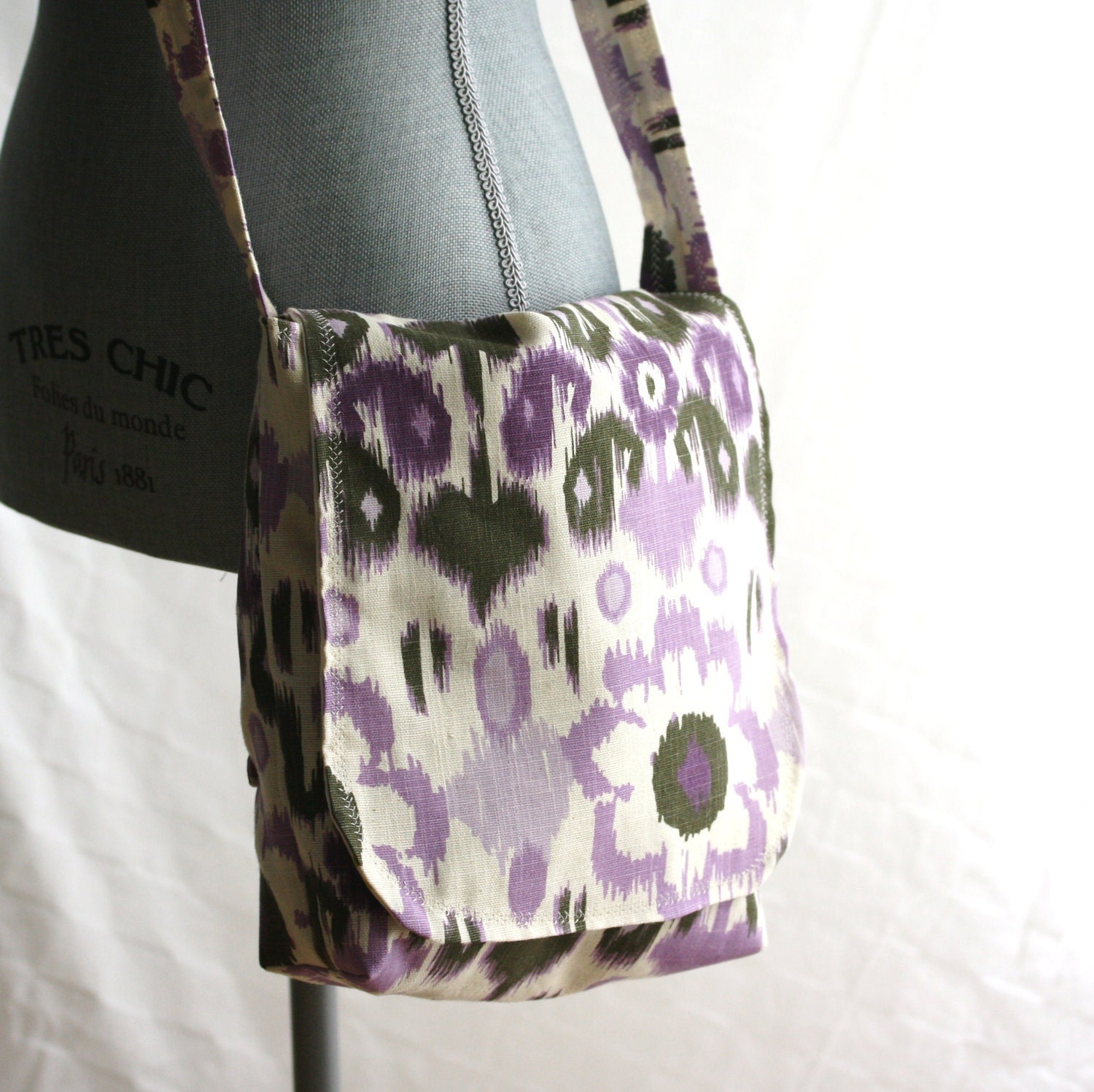 Purple Ikat messenger bag with contrasting chartreuse lattice lining. Roomy crossbody bag with flap closure.