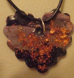 This is a two-tone clay molded heart with copper leafing for the sparkle and character