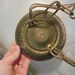 Pair of vintage 70's brass and glass swag hanging globe light fixtures